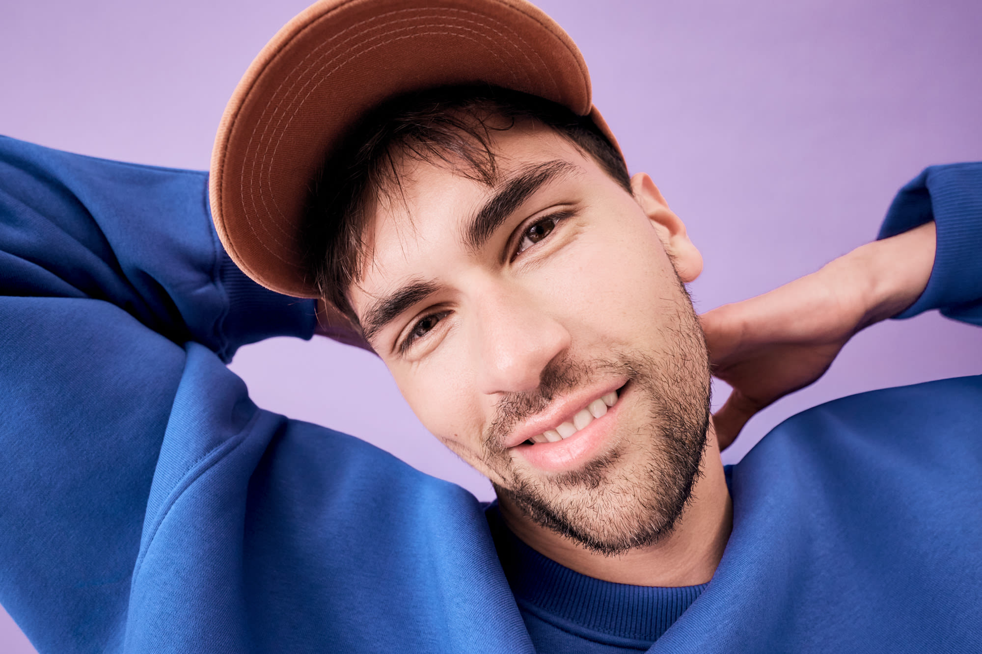 Muž s bradou sa smeje na fialovom pozadí - My Money Account Fix pre modernú finančnú organizáciu. Muž s bradou sa smeje na fialovom pozadí - My Money Account Fix pre modernú finančnú organizáciu.